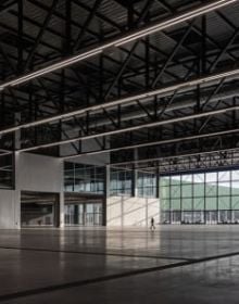Landscape shot of exterior of Toulouse Parc des expositions et Centre de convention, on grey cover, OMA – Toulouse Exhibition and Convention Center in black and grey font below.
