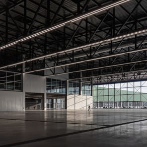 Landscape shot of exterior of Toulouse Parc des expositions et Centre de convention, on grey cover, OMA – Toulouse Exhibition and Convention Center in black and grey font below.