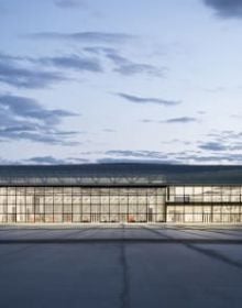 Landscape shot of exterior of Toulouse Parc des expositions et Centre de convention, on grey cover, OMA – Toulouse Exhibition and Convention Center in black and grey font below.