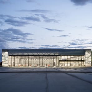 Landscape shot of exterior of Toulouse Parc des expositions et Centre de convention, on grey cover, OMA – Toulouse Exhibition and Convention Center in black and grey font below.