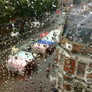 High perspective street view in London with traffic on road and Daniela Keiser London – Being in the Library in white font with text to right in white
