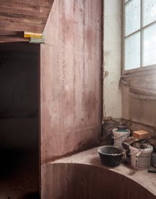 Book cover of All Under One Roof: Revolutionising Basel’s Military Barracks, with buckets of plaster and paint rollers in an interior space. Published by Park Books.