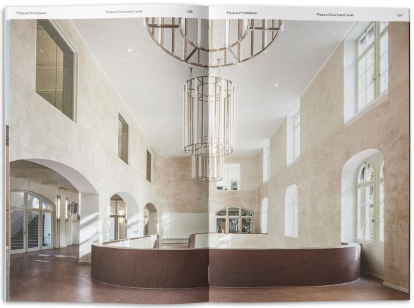 Book cover of All Under One Roof: Revolutionising Basel’s Military Barracks, with buckets of plaster and paint rollers in an interior space. Published by Park Books.