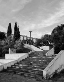 Black and white image of white high rise building complex surrounded by large trees with Hidden in Plain Sight in light orange font