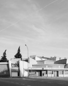 Black and white image of white high rise building complex surrounded by large trees with Hidden in Plain Sight in light orange font