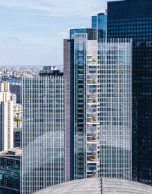 Colour photo of 32-storey high-rise Trinity tower with glass exterior shining in sunlight and Cro&Co in small white font below