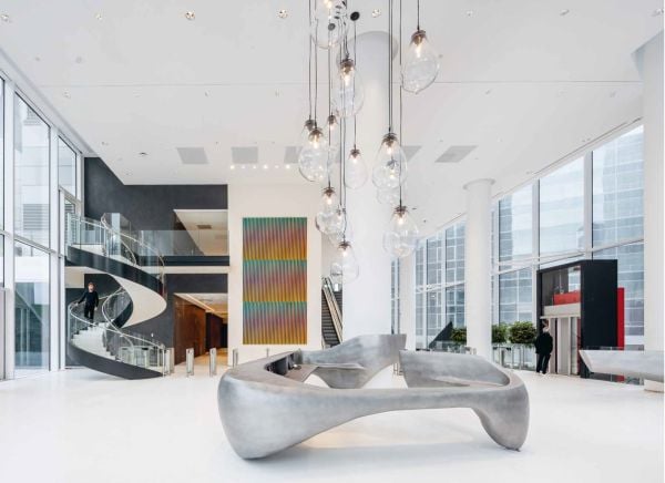 Colour photo of 32-storey high-rise Trinity tower with glass exterior shining in sunlight and Cro&Co in small white font below