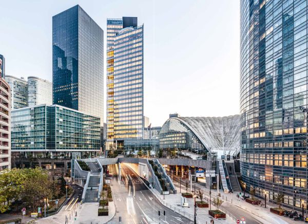 Colour photo of 32-storey high-rise Trinity tower with glass exterior shining in sunlight and Cro&Co in small white font below