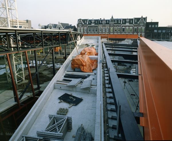 Book cover of OMA’s Kunsthal in Rotterdam, Rem Koolhaas and the New Europe, with two construction site workers standing on roof of building. Published by Park Books.