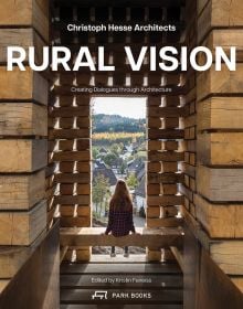 Book cover of Rural Vision: Building Dialogues Through Architecture, featuring a wood building with a person looking out onto a city, with their back to the viewer. Published by Park Books.
