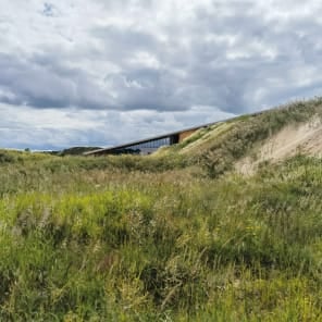 Book cover of Genuine Construction: Zhang Pengju’s New Regionalism in Inner Mongolia, featuring a modern structures surrounded by a mountainous landscape. Published by Park Books.