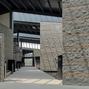 Book cover of Genuine Construction: Zhang Pengju’s New Regionalism in Inner Mongolia, featuring a modern structures surrounded by a mountainous landscape. Published by Park Books.