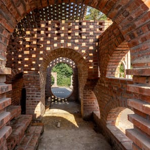Book cover of Brick 26: Outstanding International Brick Architecture; featuring a modern white brick building with perforated panels and geometric forms. Published by Park Books.