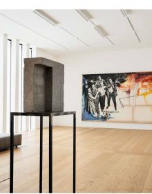 Two low black seats on pine flooring with shafts of light bursting through museum window slats with The Collection in a New Light Kunsthaus Zürich in bright yellow font