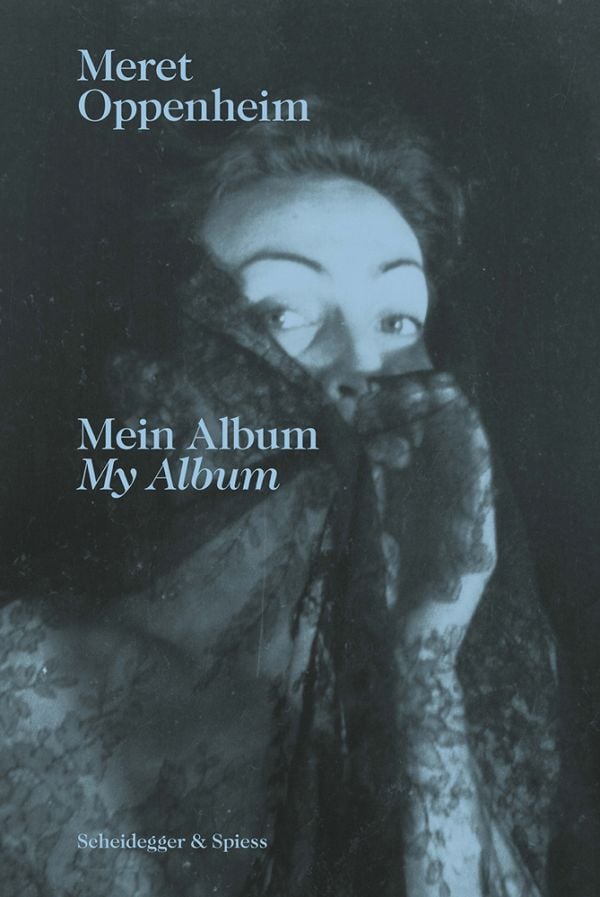 Book cover of Meret Oppenheim Mein Album My Album, featuring the artist and photographer peering through a veil of black lace. Published by Scheidegger & Spiess.