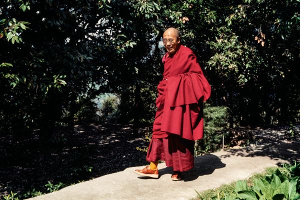 Book cover of Dalai Lama: Photographs by Manuel Bauer. 1990-2024: featuring a portrait of the head of Tibetan Buddhism. Published by Scheidegger & Spiess.