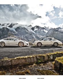 Two white Porsche models parked on mountain roadside, on grey cover of 'Cars & Curves, A Tribute to 70 Years of Porsche', by Delius Klasing.