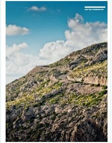 Curved road with mountainous landscape behind, on cover of 'Curves: Mallorca', by Delius Klasing.