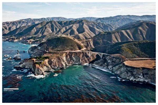 Aerial view of winding road in rocky mountain, near sea, on cover of 'Curves: USA - California', by Delius Klasing.