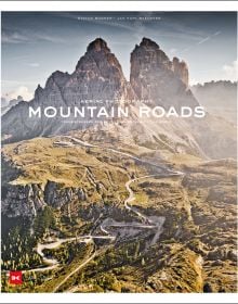 Mountainous landscape with green terrain with winding roads, on cover of 'Mountain Roads, Aerial Photography. Traumstraßen der Welt / Dreamroads of the world', by Delius Klasing Verlag GmbH.