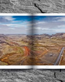 Mountainous landscape with green terrain with winding roads, on cover of 'Mountain Roads, Aerial Photography. Traumstraßen der Welt / Dreamroads of the world', by Delius Klasing Verlag GmbH.