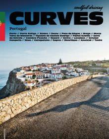 Road traveling towards homes by the sea, on cover of 'Curves: Portugal, Band 14', by Delius Klasing.