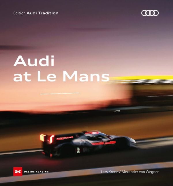 Book cover of Audi in Le Mans, with a blurred Audi R8 racing car on track. Published by Delius Klasing Verlag GmbH.
