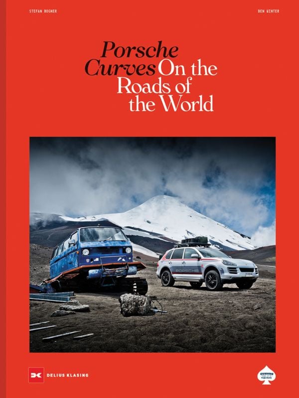 Book cover of Stefan Bogner's Porsche Curves: On the Roads of the World, with a VW transporter with caterpillar tracks and a Porsche Cayenne. Published by Delius Klasing Verlag GmbH.