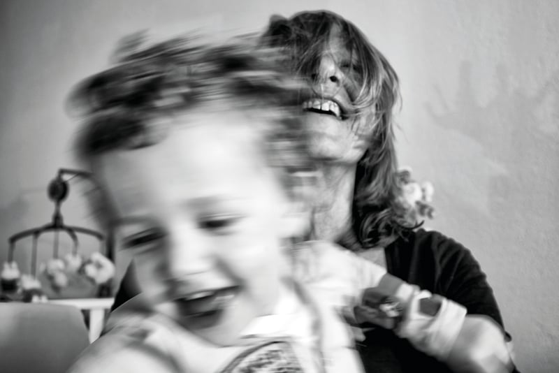 Black and white shot woman smiling in motion blur, SILVER Irene van Nispen Kress in silver and white font to centre.