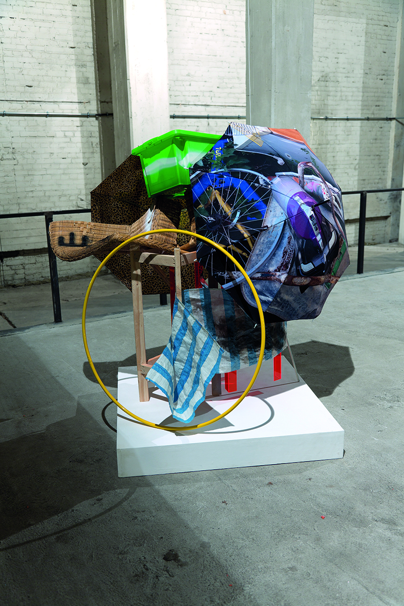 Sections of fabric with various prints, Sibylle Jazra Arbeiten 2009-2019 in purple font to white centre banner.