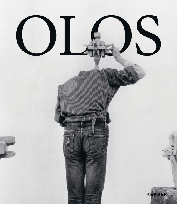 Book cover of Mihai Olos, with the artist in the studio, leaning forward, while holding a wooden object above his head. Published by Kerber.
