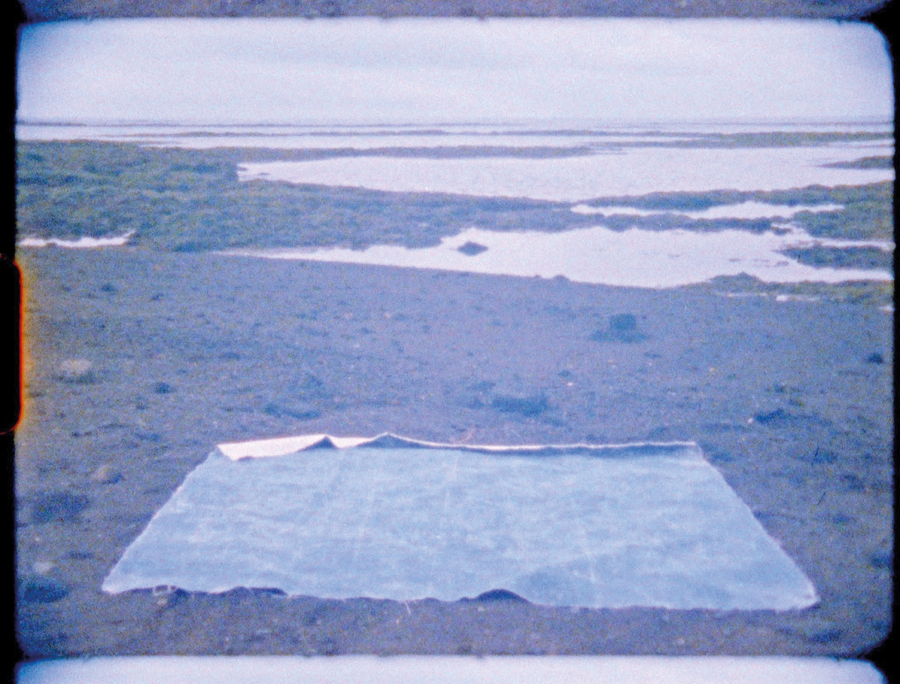 Pale grey cover with blue filter photo of landscape with piece of fabric on ground and Elín Jakobsdóttir in blue font above