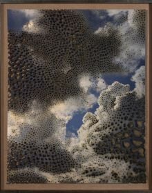 Blue sky with white clouds, small irregular shapes in copper, Miguel Rothschild PREMONITION, in navy font to grey banner to bottom left of cover.