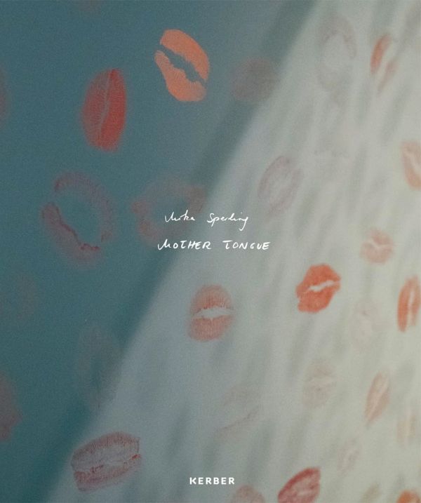 Book cover of Mika Sperling: Mother Tongue, with a wall covered with pale pink lipstick kiss marks. Published by Kerber.