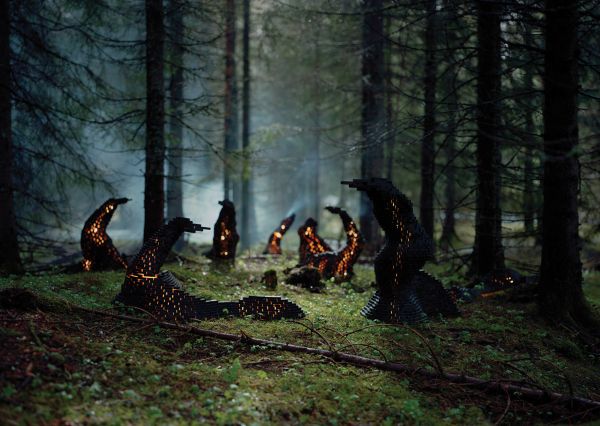Book cover of Rune Guneriussen Lights go out, with a light installation on wood structure, in a dark forest setting. Published by Kerber.