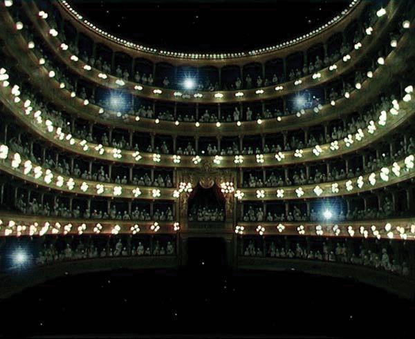 Book cover of Opera Opera: Allegro ma non troppo, with a string of illuminated light bulbs hanging down in exhibition space. Published by Kerber.