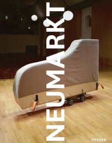 Grand piano with cover, resting vertically on moving trolley, on concert stage, on cover of 'Neumarkt, with photographs by Frank Schinski', by Kerber.