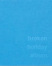 broken holiday album in embossed text to bottom right corner on bright blue cover.