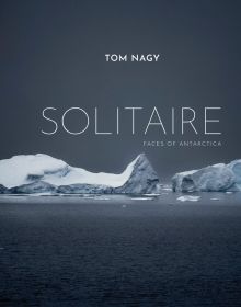 Two large icebergs floating on water in Antarctica, TOM NAGY, SOLITAIRE, in white font above.