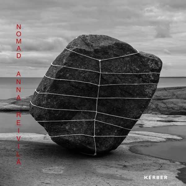 Book cover of Anna Reivilä, Nomad, with a large grey rock bound in rope, on coastal edge. Published by Kerber.