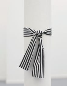 Book cover of Cinthia Marcelle, By Means of Doubt', with a red and white striped fabric tied with a bow. Published by Kerber.