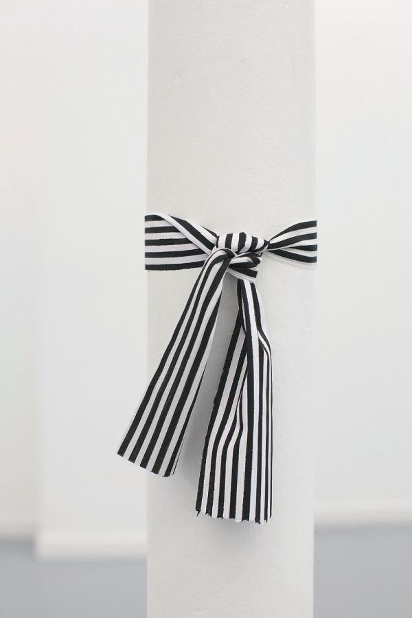 Book cover of Cinthia Marcelle, By Means of Doubt', with a red and white striped fabric tied with a bow. Published by Kerber.