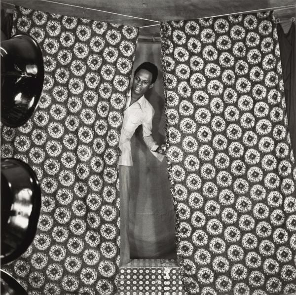 Book cover of The Struggle of Memory, Works from the Deutsche Bank Collection, with artist standing in front of large painting with curved road. Published by Kerber.