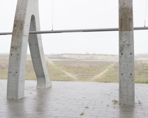 Multi-storey structure obscured by mist, on grey landscape cover of 'Piet Niemann, Expo 2000', by Kerber.