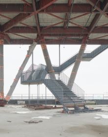 Multi-storey structure obscured by mist, on grey landscape cover of 'Piet Niemann, Expo 2000', by Kerber.