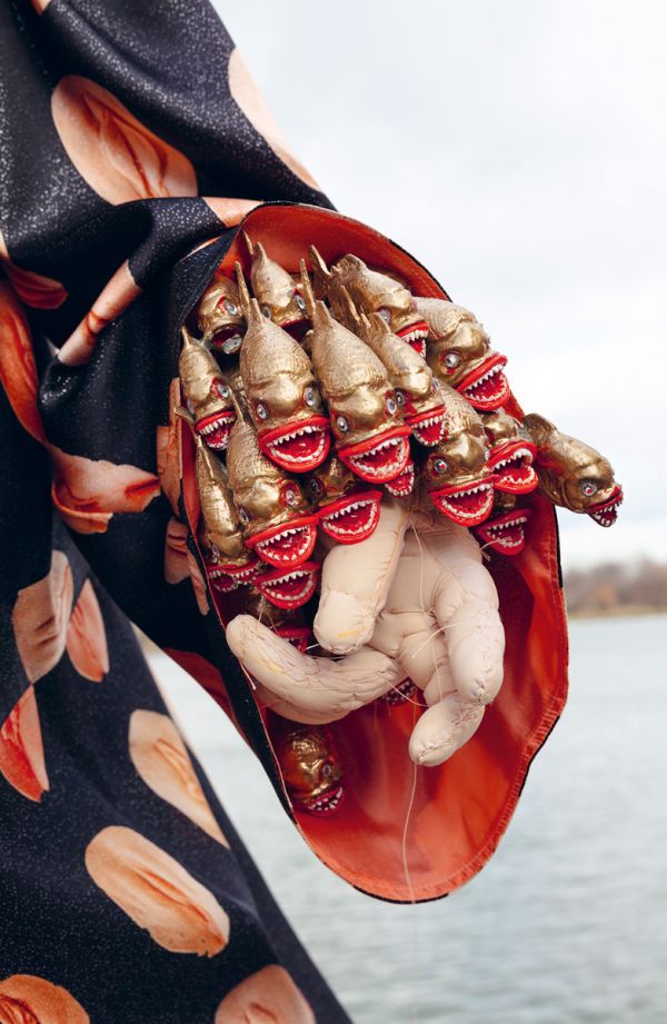 Terracotta sculpture of spiky ball with flower-like head, on cover of 'Ines Doujak, Nichtsdestoweniger. Nevertheless', by Kerber.