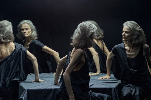 Landscape book cover of René Riis, Conversation with My Other Me, with mirrors creating five images of the same man with large grey beard, wearing a red and white checked jacket, sitting at table. Published by Kerber.