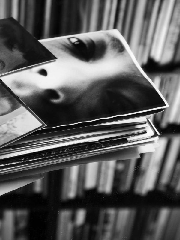 Repeated slide of pair of eyes, on mustard yellow cover of 'MOMENTA Biennale de l’image, Mascarades. L’attrait de la métamorphose', by Kerber.