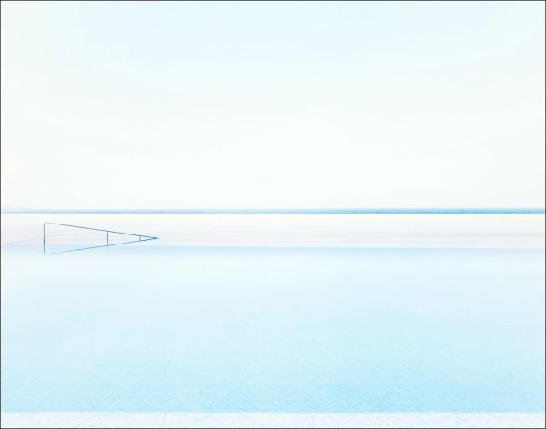 White landscape book cover of Rainer Zerback, The World Without Us, featuring a seascape with diving platform, misty mountains behind. Published by Kerber.