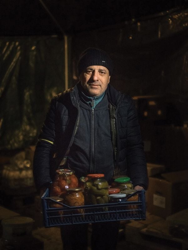 Book cover of Faces of War: Alexander Chekmenev, featuring a lone figure with a fire raging behind. Published by Kerber.
